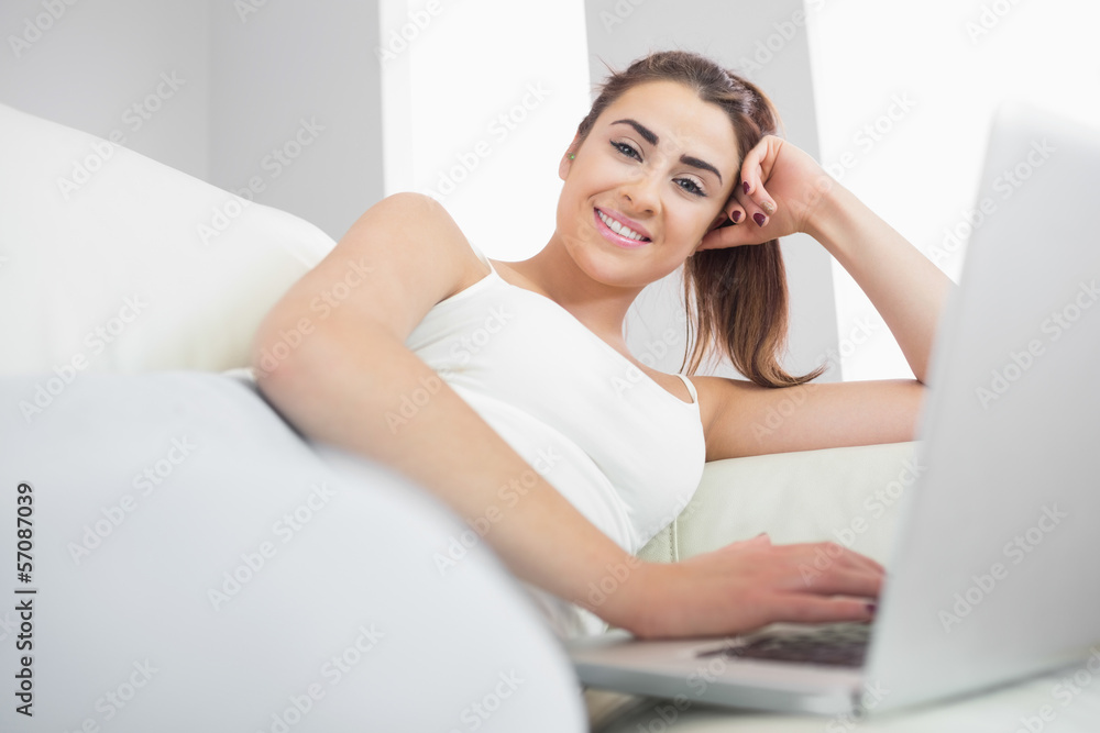 Cheerful woman using her notebook Cheerful woman using her notebook