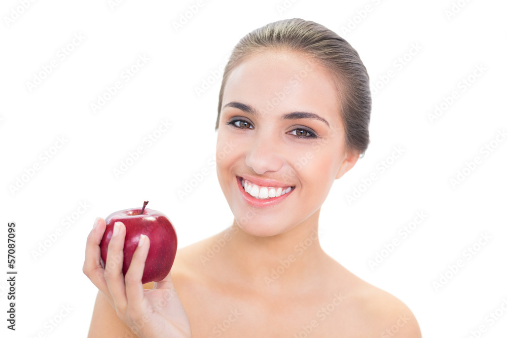 Happy young brunette woman holding a red apple Happy young brunette woman holding a red apple