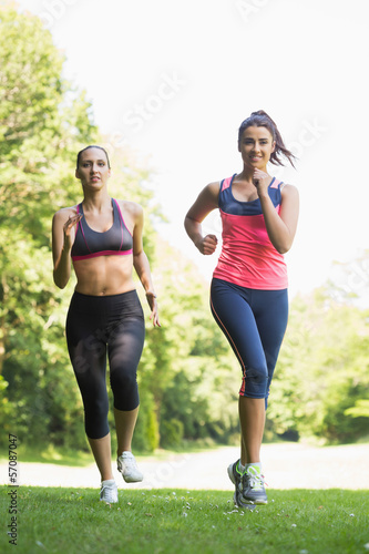 Two fit brunette women jogging