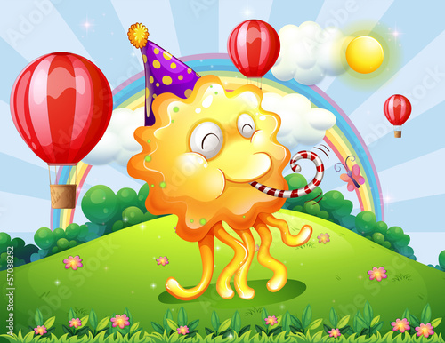 A very happy monster at the hilltop with a rainbow