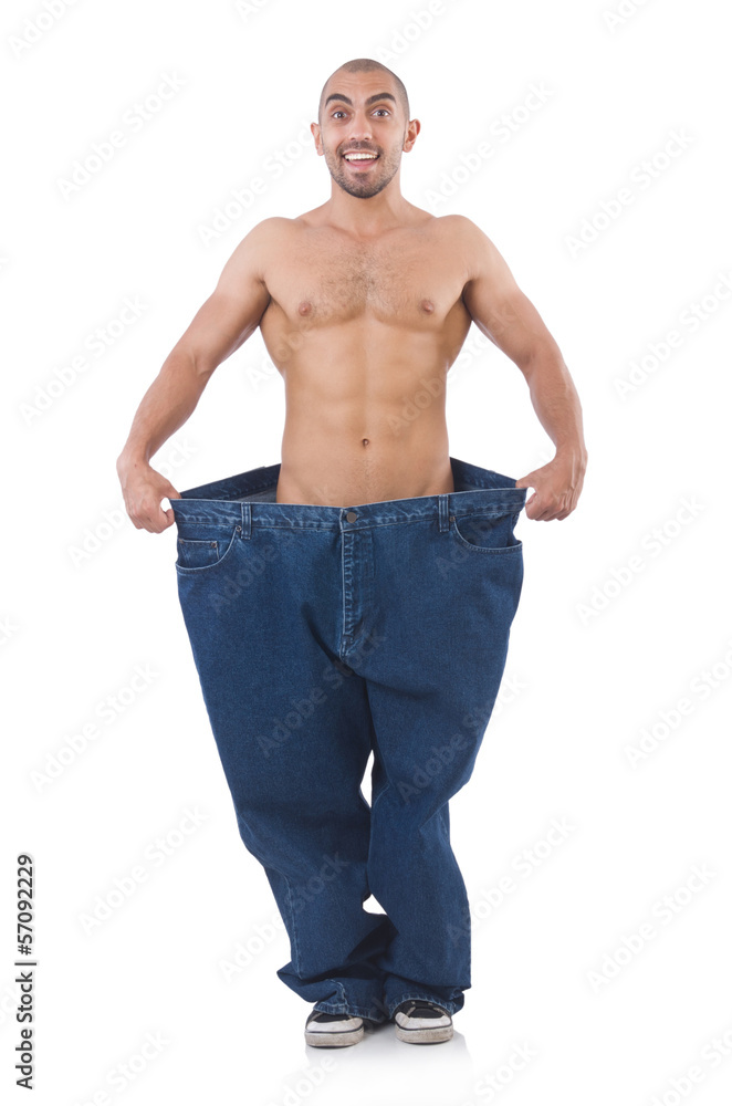 Man in dieting concept with oversized jeans