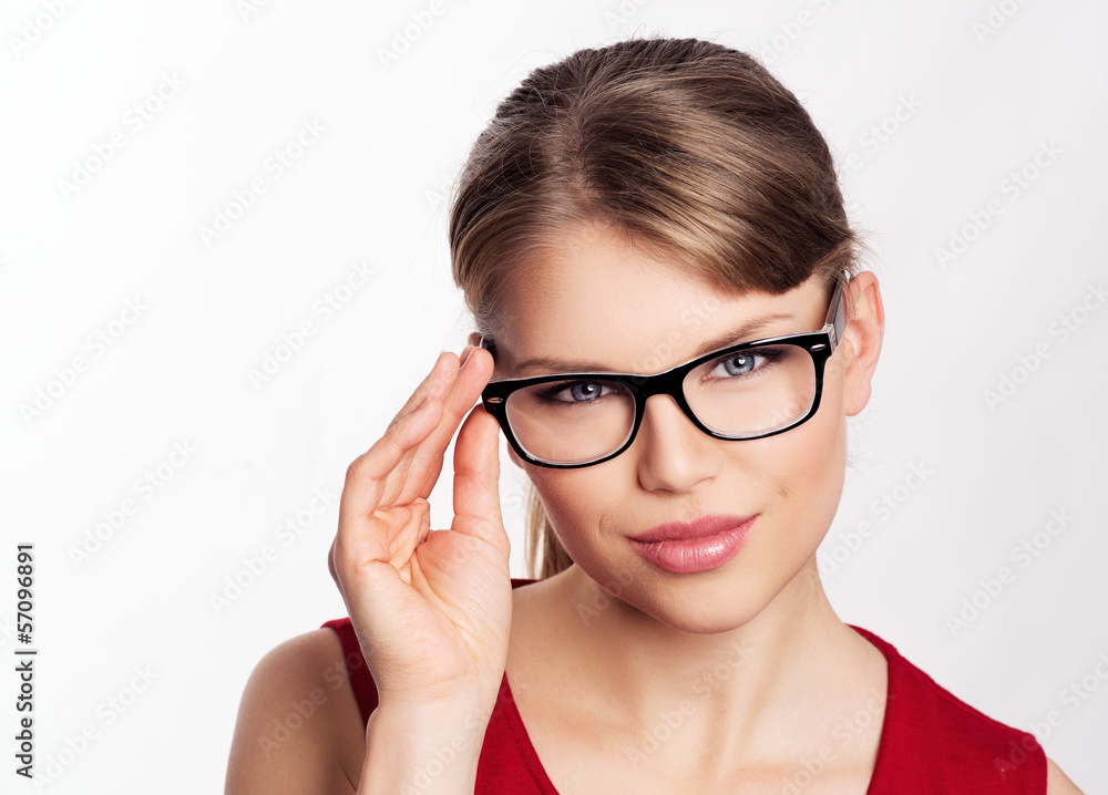 Beautiful blonde in stylish eyewear posing in studio.