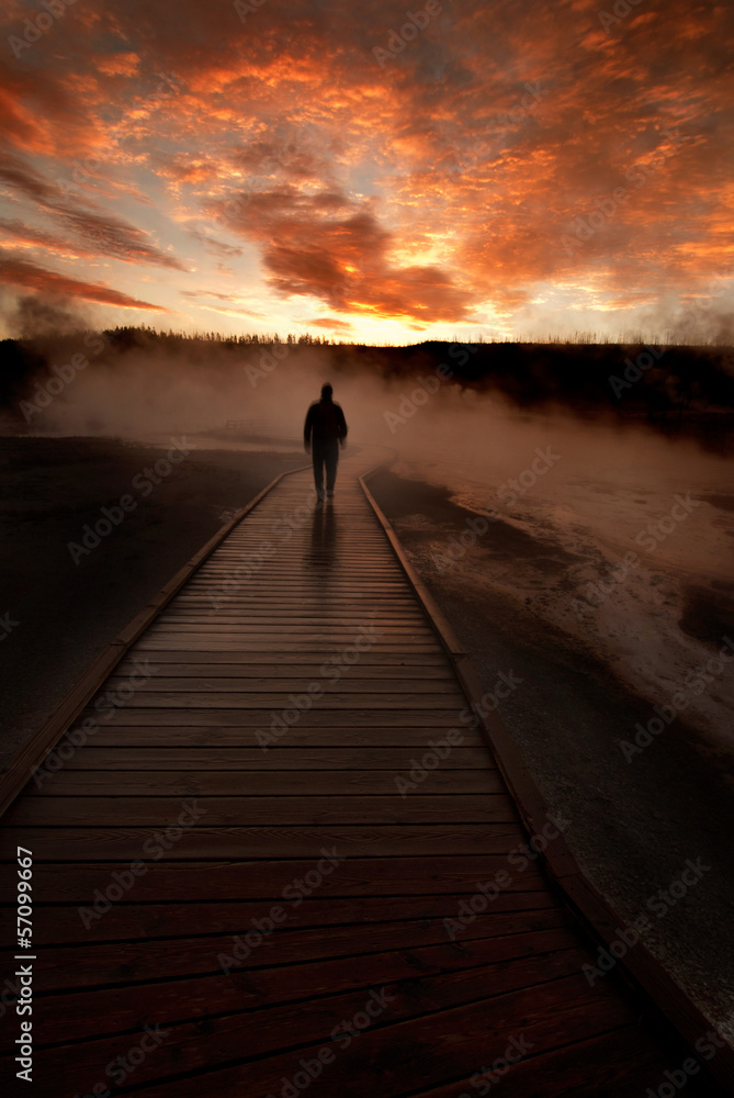 Fototapeta premium Sunrise Yellowstone Geysers with Man Silhouetted