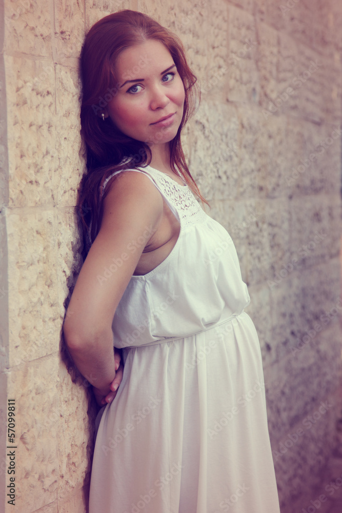 Young Beautiful pregnant woman near the wall