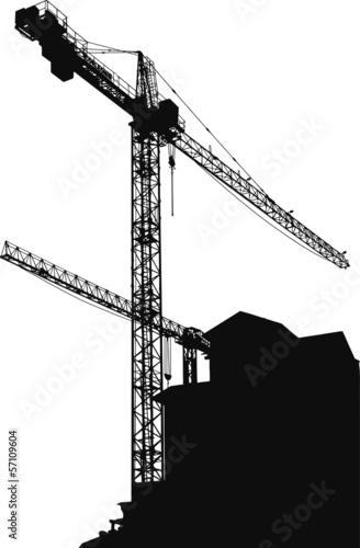Silhouettes of cranes on building