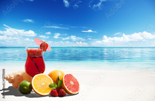 strawberry cocktail and tropical fruit on the beach