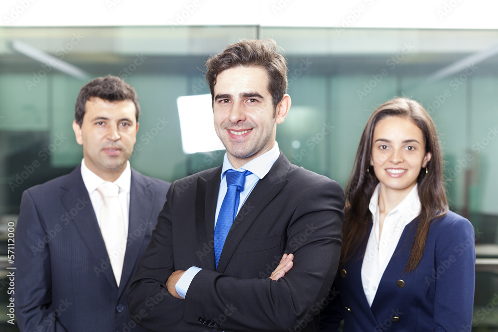 Confident businessman leader on the foreground of his team Confident businessman leader on the foreground of his team