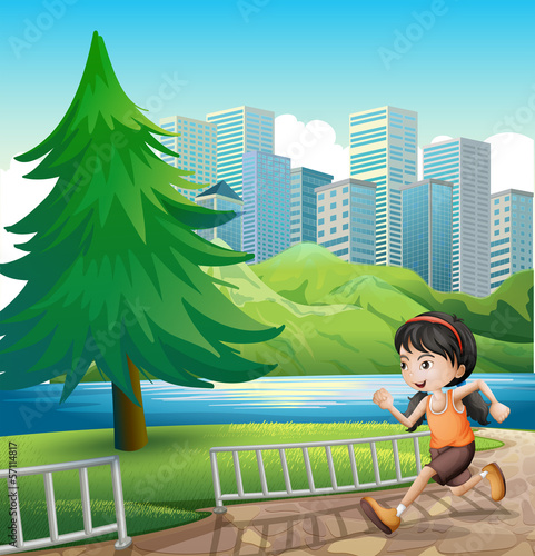 A young girl running at the riverbank