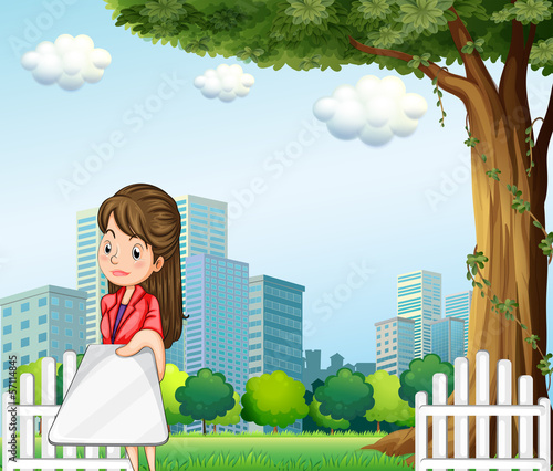 A woman using her gadget in front of the buildings