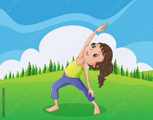 A cute little girl exercising at the hilltop
