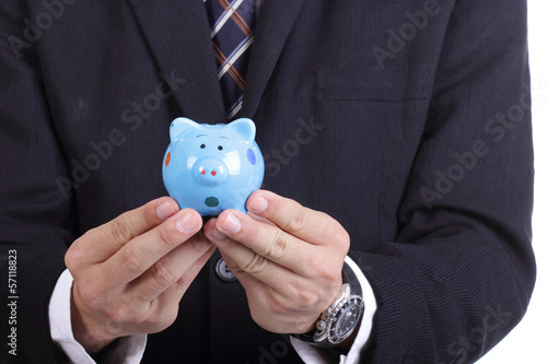 Businessman holding Piggy bank officer put money inside