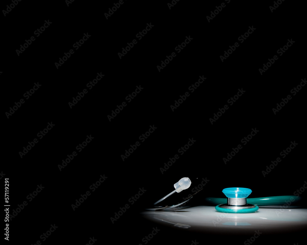 Stethoscope in a spotlight on black background Stethoscope in a spotlight on black background