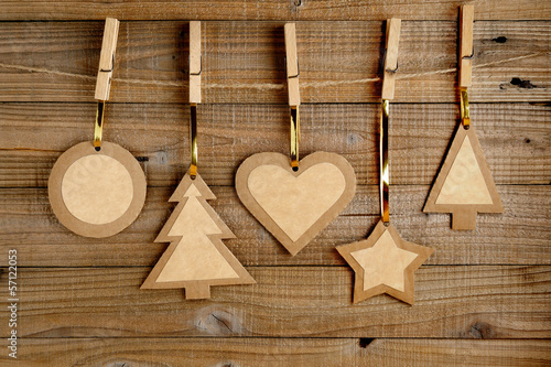 Old paper christmas decorations on wooden background
