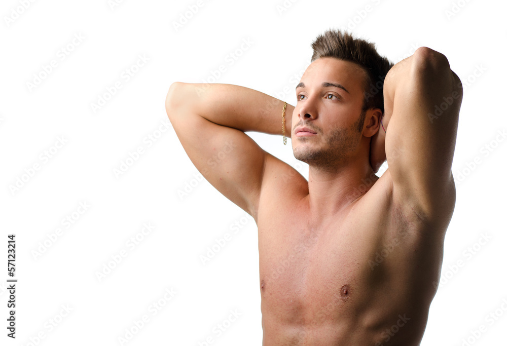 Handsome and fit young man naked with hands behind his head