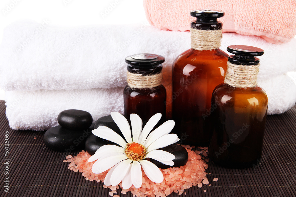 Beautiful spa setting with flower on bamboo mat close up Beautiful spa setting with flower on bamboo mat close up