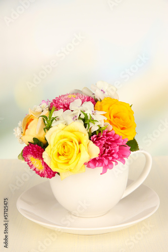 Beautiful bouquet of bright flowers in color mug 