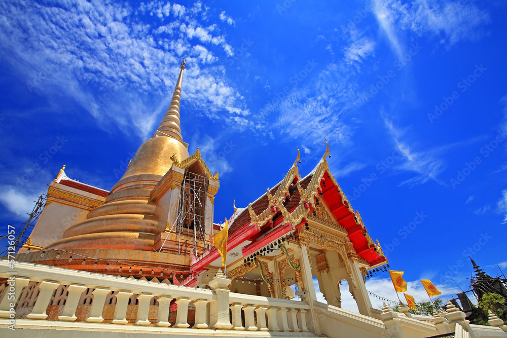 Thai gold pagoda against blue sky