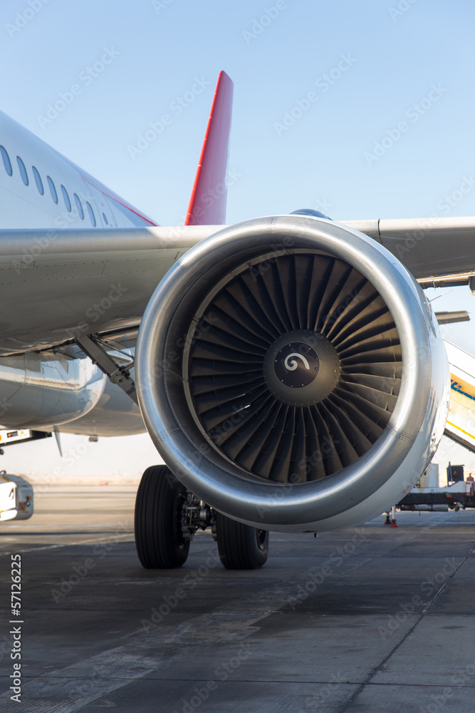 Fototapeta premium wing and engine of passenger airplane in airport