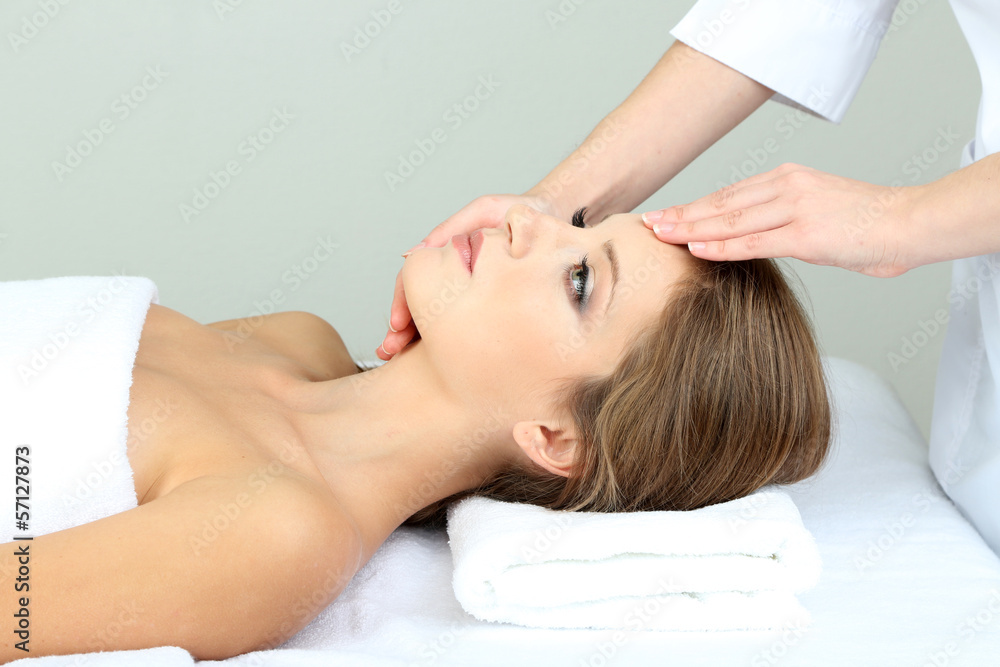Beautiful young woman during facial massage in cosmetic salon Beautiful young woman during facial massage in cosmetic salon