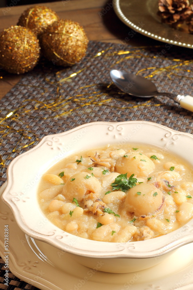 Cuttlefish and white beans stew on a Christmas table