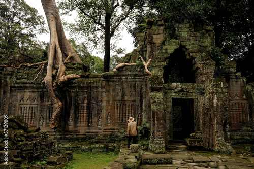 angkor - prheah khan temple  archaeologist explores the ruins