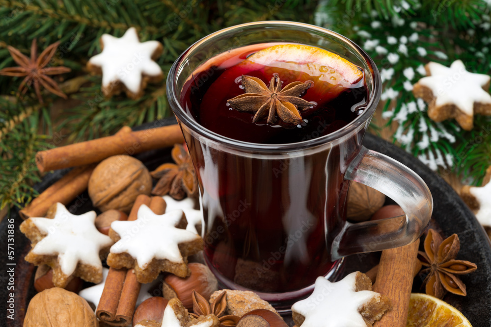 cup of mulled wine, cookies in the shape of stars and spices cup of mulled wine, cookies in the shape of stars and spices