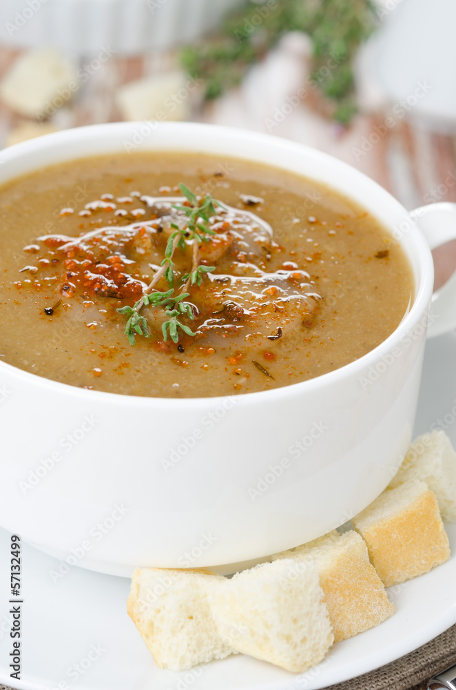 Mushroom cream soup with croutons and thyme in a bowl close-up Mushroom cream soup with croutons and thyme in a bowl close-up