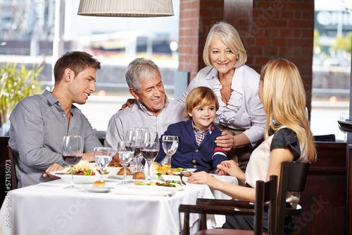 Gl  ckliche Familie sitzt im Restaurant