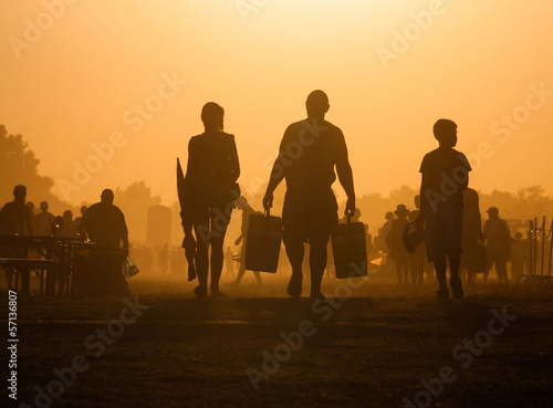 People traveling in the sunset