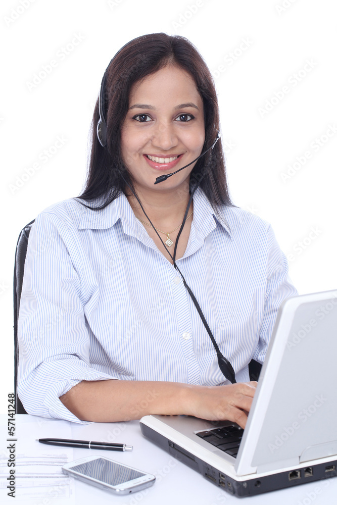 Beautiful young Indian call centre woman against white Beautiful young Indian call centre woman against white