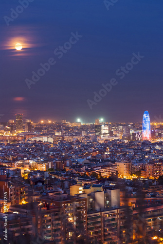 Barcelona at night with full moon, Spain © dinozzaver