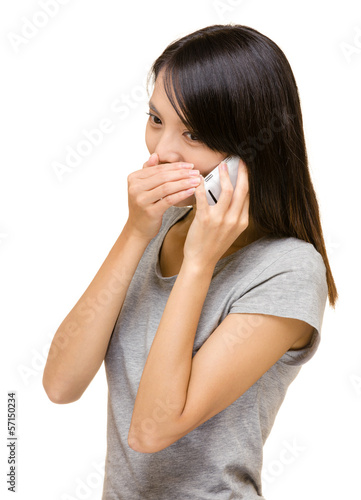 Asian woman talking secret on phone