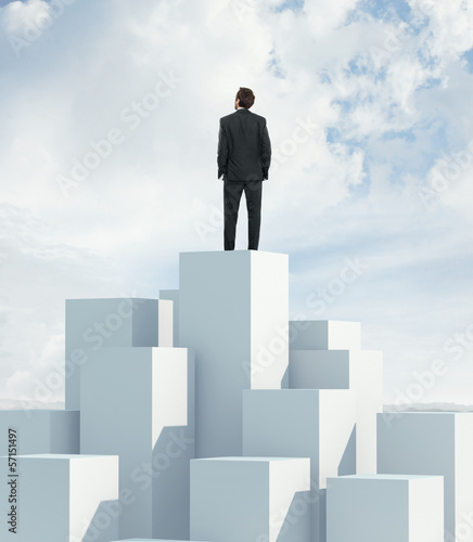 man standing on highest cube