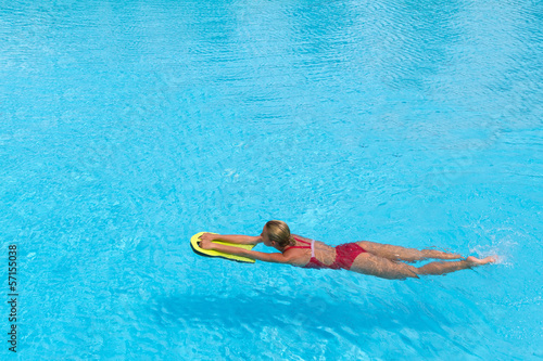 Woman during practice with board from polyfoam for swimming photo