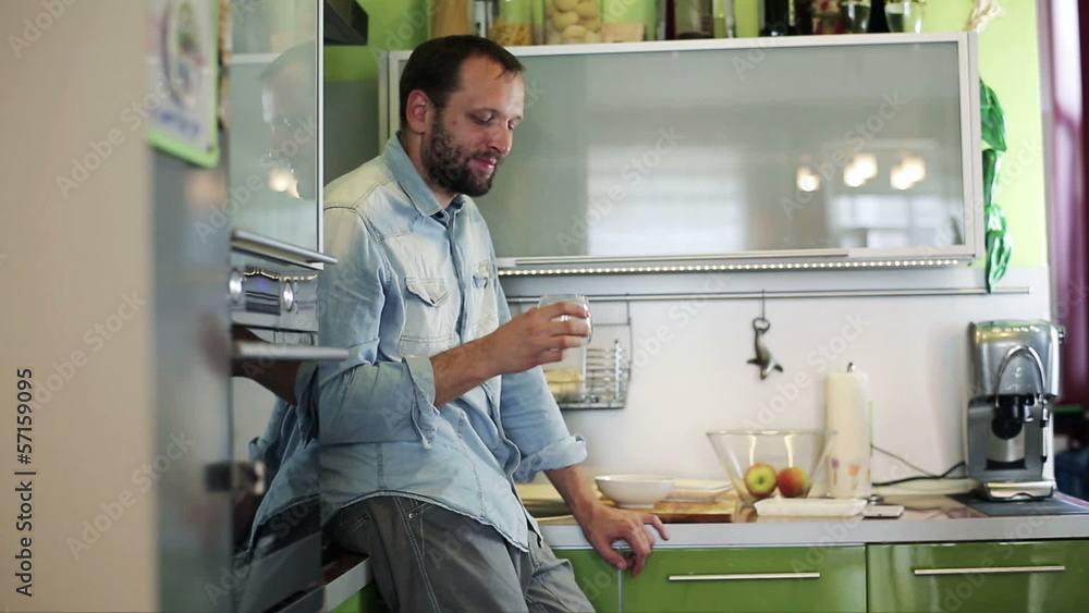 Man drinking whisky in the kitchen Man drinking whisky in the kitchen