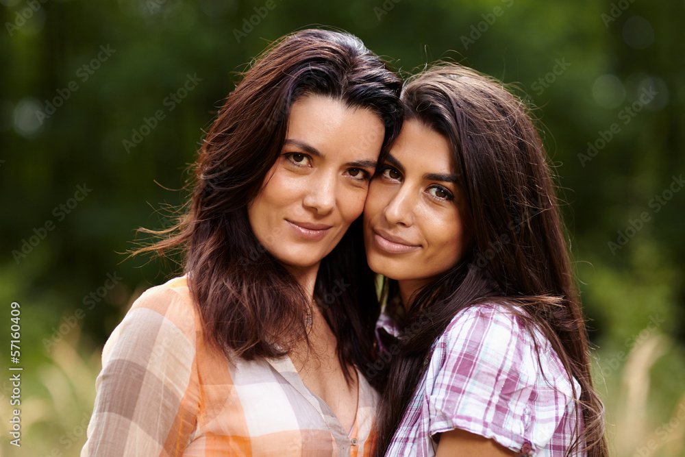 Fototapeta premium Mother and daughter staying cheek to cheek