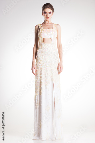 beautiful woman model posing in elegant white pearl dress