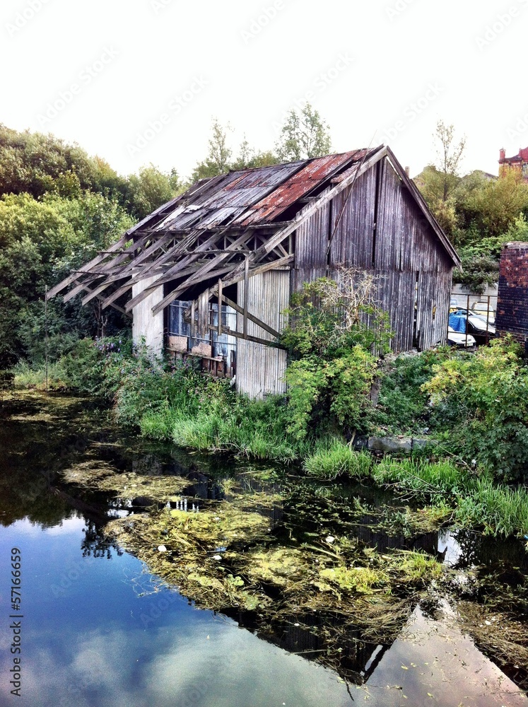 abandoned derilict old warehouse next to canal in leeds uk abandoned derilict old warehouse next to canal in leeds uk
