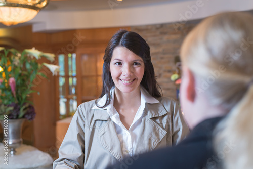 Smiling female guest in a hotel lobby