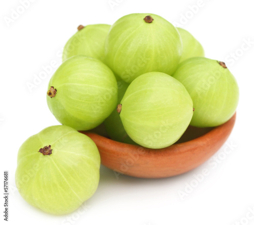 Fresh amla with a small brown bowl