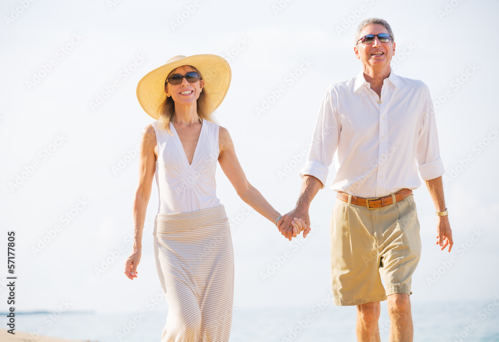 Middle Aged Couple Enjoying Walk on the Beach Middle Aged Couple Enjoying Walk on the Beach