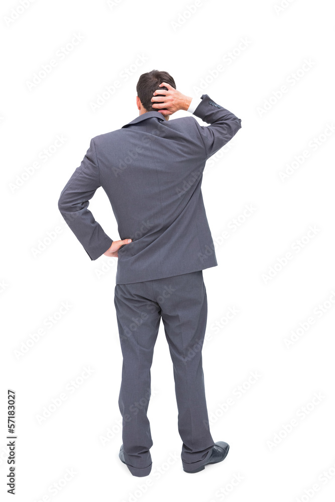 Young businessman standing back to camera scratching his head Young businessman standing back to camera scratching his head