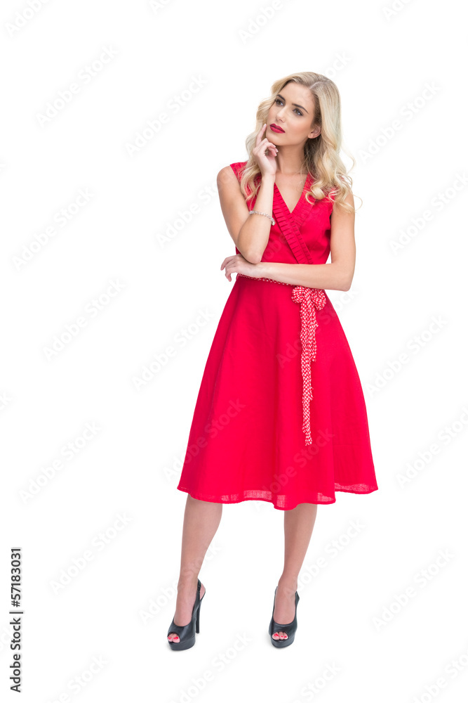 Thoughtful woman posing in red dress