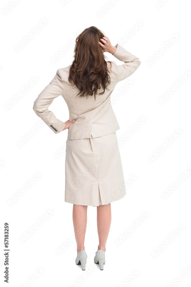 Businesswoman standing back to camera with hand on head Businesswoman standing back to camera with hand on head