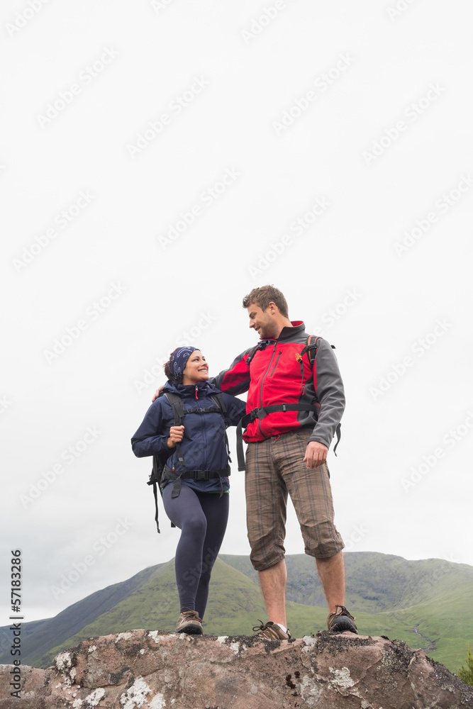 Couple standing on a rock embracing