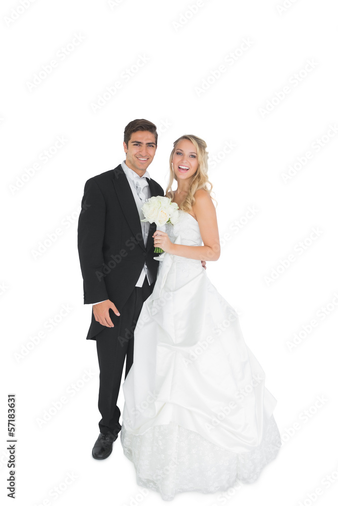 Cheerful young married couple posing smiling at camera
