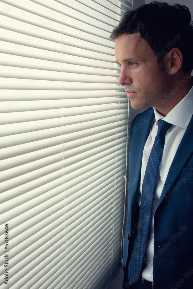 Stern handsome businessman looking out of window Stern handsome businessman looking out of window