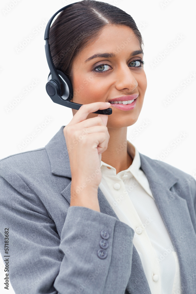 Smiling female call centre agent with her headset Smiling female call centre agent with her headset