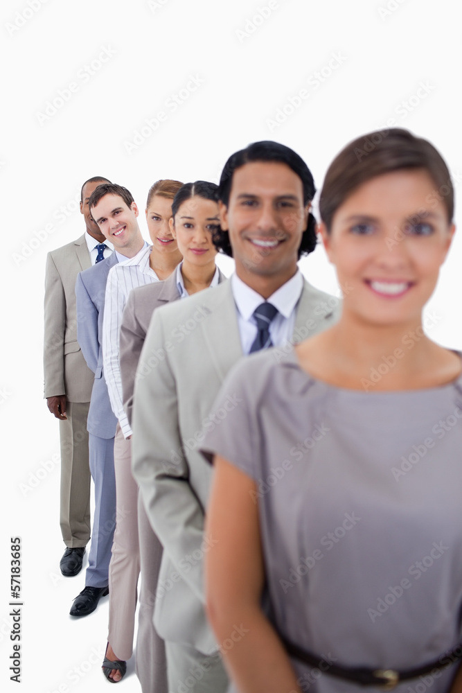 Close-up of workmates in a single line smiling and looking strai Close-up of workmates in a single line smiling and looking strai