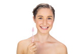 Cheerful young model holding toothbrush